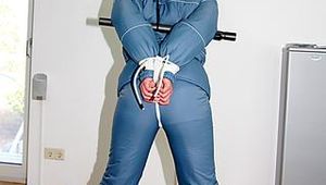 Jill tied, gagged and hooded wearing a shiny blue downwear (Pics)