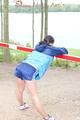 Enni wearing sexy shiny nylon shorts and rain jacket while stretching herself on a sea (Pics)
