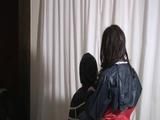 two of our archive girls tied and gagged in shiny nylon rainwear