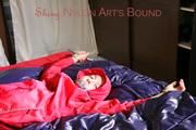 Sonja tied, gagged and hooded on bed with cuffs, chains and a gag wearing a sexy blue shiny nylon rain pants and a red rain jacket (Pics)
