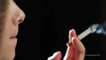 A young lady showing her smoking skills in a closeup video 