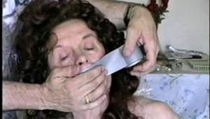 69 yr OLD TAPE WRAP GAGGED, HUMILIATED TOPLESS HOSTAGE (D14-4)
