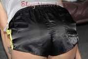 Watching Pia preparing her bed wearing a sexy black shiny nylon shorts and a grey tshirt (Pics)
