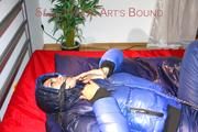 Lulu ties, gagges and hoodes herself on a bed with cuffs wearing a sexy black/blue shiny nylon down jacket and a darkblue rain pants (Pics)