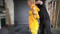 Ms Ungeniert tied and gagged in shiny nylon Rainwear trying to escape