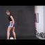 Brown-haired archive girl posing with an soccer ball wearing shiny nylon shorts and a rain jacket (Video)
