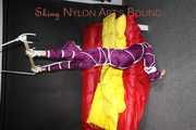 Watching sexy Sonja wearing a supersexy purple shiny nylon rainwear combination being tied and gagged overhead with ropes and a clothgag (Pics)