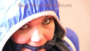 Jill tied and gagged on bed wearing a shiny black pants and a shiny blue rain jacket (Pics)