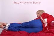 Pia tied and gagged on bed in a shiny bluerainpants and red rainjackert (Pics)