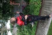Watching sexy Sandra wearing a oldschool black/red shiny nylon rainwear combination while gardening outside (Pics)