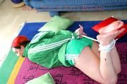 Jill tied and gagged on the floor wearing a hot green shiny nylon shorts and a rain jacket (Pics)
