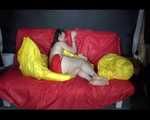 Sexy Mara wearing only a red shiny nylon shorts lolling and posing on the sofa (Video)