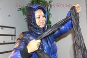 Lulu ties, gagges and hoodes herself on a bed with cuffs wearing a sexy black/blue shiny nylon down jacket and a darkblue rain pants (Pics)