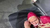 Alice bound and gagged in a nylon Rainsuit