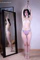 Tracy: topless barefoot girl with noose on her neck, having her to stand on her tip toes to breathe, is tickled by camera man