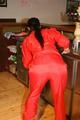 Jill posing in a bar wearing a sexy red rainwear combination with nothing under it (Pics)