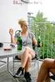 Jenny and a friend of her sitting on the balcony with eachother wearing sexy shiny nylon shorts ans tops (Pics)