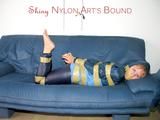 Leoni tied, gagged and hooded with tape wearing a sexy blue rainwear combination (Pics)