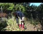 Mara wearing only a hot rain jacket and rubber boots lingering in the garden taking a shower (Video)