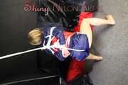 SANDRA being tied and gagged overhead with ropes and a clothgag wearing a sexy oldschool shiny nylon shorts and a rainjacket (Pics)