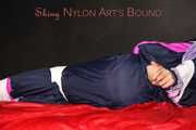 Watching Pia wearing blue/pink shiny nylon rainwear being tied and gagged and hooded with tape and a clothgag (Pics)
