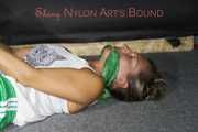 Watching sexy Sandra wearing a sexy green shorts and a white top being tied and gagged on the floor with ropes and a cloth gag (Pics)