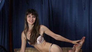 Jessica in polka dot bra and panties, cuffed with steel cuffs on her hands and ankles, poses and stimulates herself