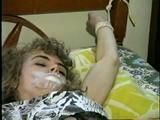 TINY TINA BALL-GAGGED, RING-GAGGED, CLEAVE GAGGED, TOE-TIE & TIED UP SITTING ON A CRATE (D34-3)