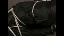 4 short videos in one of an beautiful black haired archive girl tied and gagged on the floor wearing sexy shiny nylon rainwear (Video)