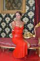 Miss Scarlett bound and gagged in a long red Latex dress