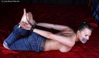 Tapegagged topless barefoot Peggy, hogcuffed with heavy steel cuffs