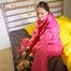 Lucy tied and gagged with a bar on a bed wearing a sexy pink shiny nylon rain pants and a rain jacket (Pics)