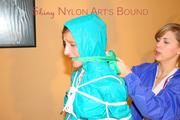 Leonie ties and gagges Stella wearing sexy shiny nylon rainwear (Pics)