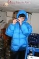 Jill posing in a cooling room wearing a shiny nylon rainpants and a down jacket (Pics)