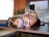 Hogtied on a table 