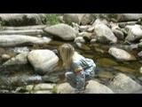 Sophie enjoying the water and weather on a river wearing supersexy grey sauna pvc rainwear (Video)
