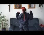 Jill DIamond lolling on a sofa wearing supersexy shiny rainwear (Video)