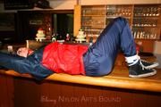 Jill tied and gagged in shiny rainwear