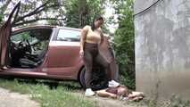 Mistress Jenna stands on the slave with a car while smoking in the slave's mouth B