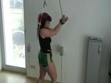 Archive girl tied and gagged and crotchroped upright on a rope winch wearing a hot green shiny nylon shorts (Video) 