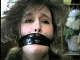 ERICA IS MOUTH STUFFED, WRAP TAPE GAGGED & BALL-TIED (D29-8)