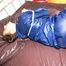 Stella tied and gagged in shiny nylon rainwear
