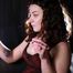 Dark-haired Russian girl smoking a cigarette on the studio couch