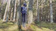 Sebastien breathplay tied up in a puffer jacket among the trees.