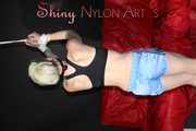 Watching ***NEW MODELL COURTNEY*** wearing a sexy lightblue shiny nylon shorts and a black top being tied and gagged overhead with ropes and a ballgag (Pics)