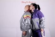 Sophie tied and gagged by Jill on a sofa wearing a shiny silver PVC sauna suit which is slitted by Jill (Pics)