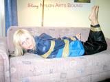 Archive girl tied and gagged with tape and rope wearing shiny nylon rainwear in blue (Pics)