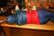 An archive girl tied and gagged on a bar wearing shiny nylon rainwear (Pics)