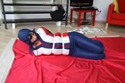 Julia tied and gagged in a shiny nylon skisuit