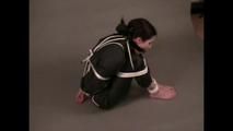 4 short videos in one of an beautiful black haired archive girl tied and gagged on the floor wearing sexy shiny nylon rainwear (Video)